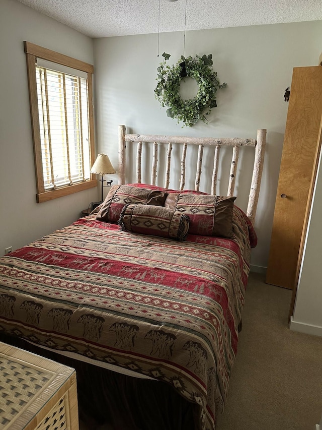 carpeted bedroom featuring a textured ceiling