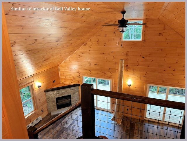 interior space with tile patterned floors, wood walls, vaulted ceiling, wooden ceiling, and ceiling fan