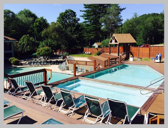 view of swimming pool with a deck