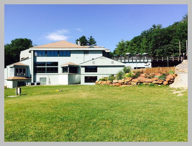 rear view of property featuring a yard