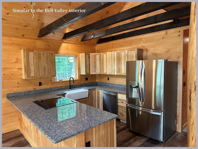 kitchen featuring sink, light brown cabinets, appliances with stainless steel finishes, wooden walls, and kitchen peninsula