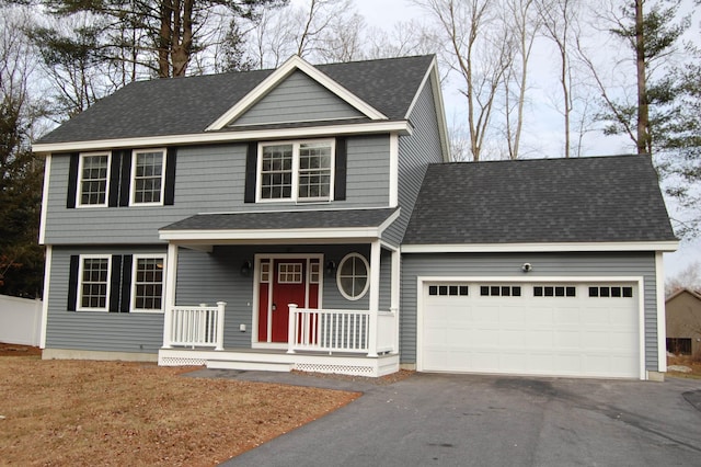 view of front facade with a garage and a porch