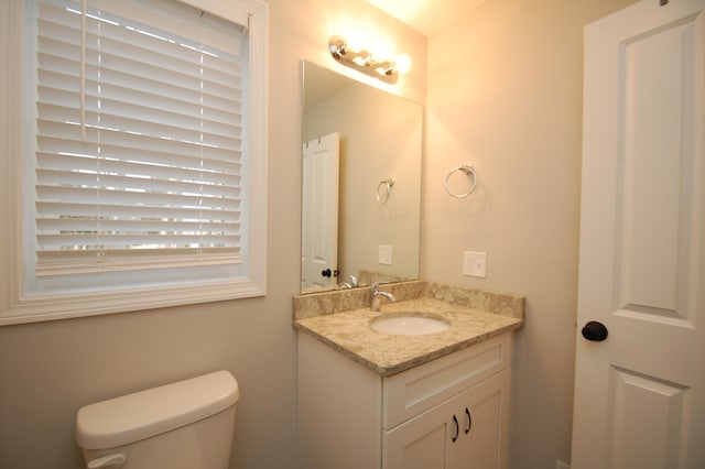 bathroom featuring vanity and toilet