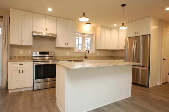 kitchen with white cabinetry, stainless steel appliances, a center island, and hanging light fixtures