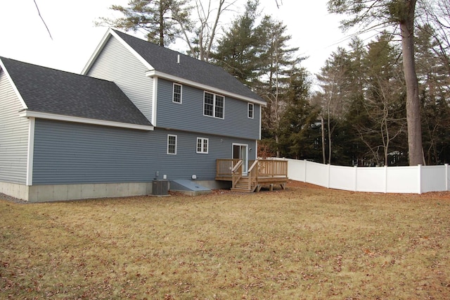 back of house featuring a wooden deck, a yard, and central air condition unit