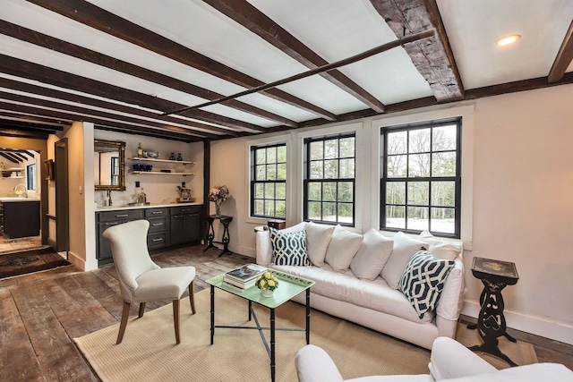 living room with beam ceiling, bar, and dark hardwood / wood-style floors