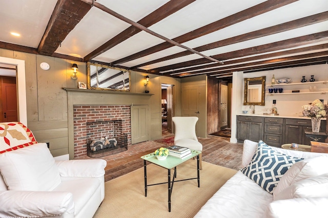 living room with beamed ceiling and light hardwood / wood-style flooring