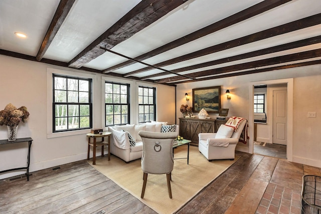 living room with beam ceiling and light hardwood / wood-style flooring