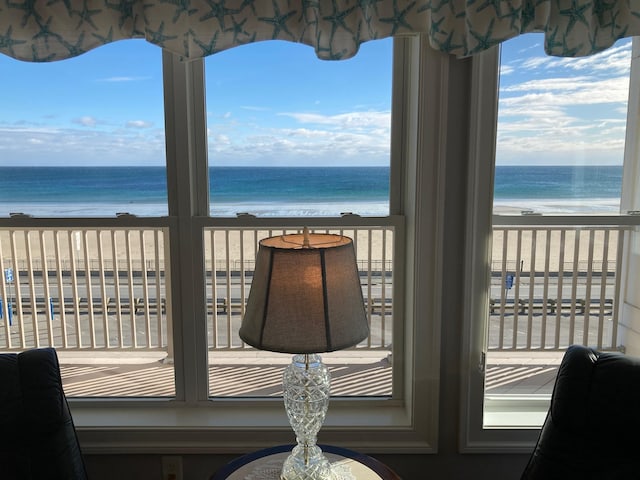 interior space featuring a beach view and a water view