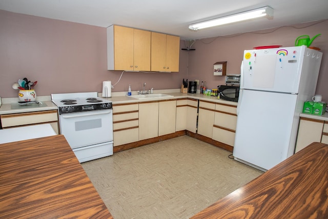 kitchen featuring sink, white appliances, and light brown cabinets