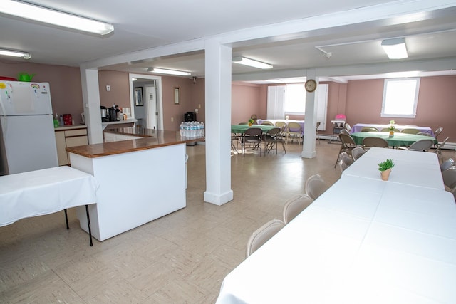 kitchen with butcher block counters and white fridge