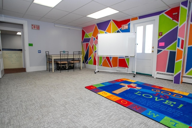 playroom featuring carpet floors and a paneled ceiling