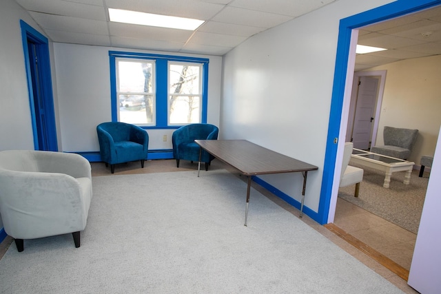 sitting room featuring carpet flooring, a paneled ceiling, and a baseboard radiator