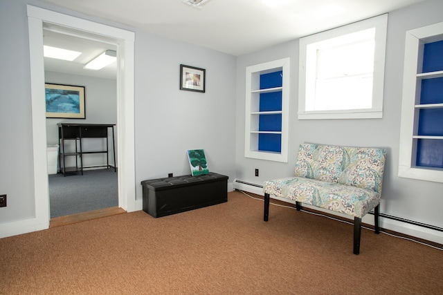 sitting room featuring carpet flooring and built in shelves