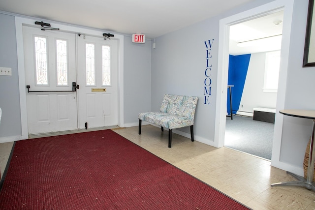 foyer featuring a baseboard radiator and plenty of natural light