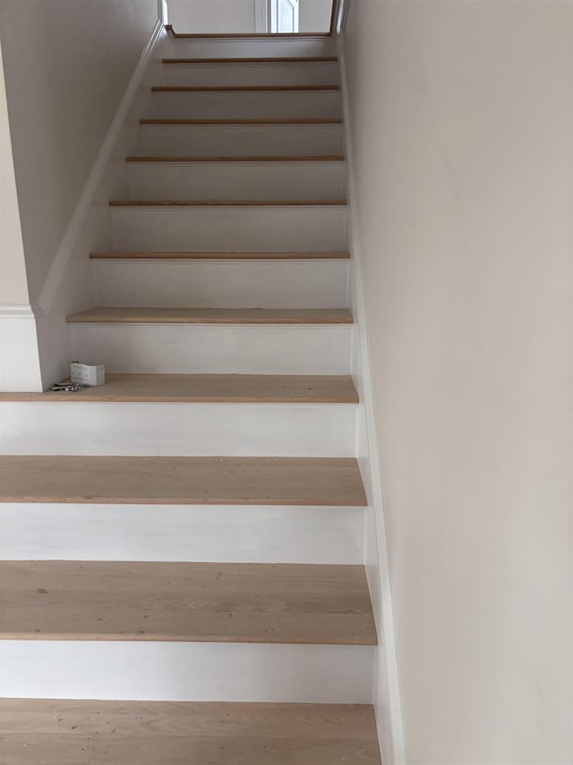 stairway with hardwood / wood-style floors