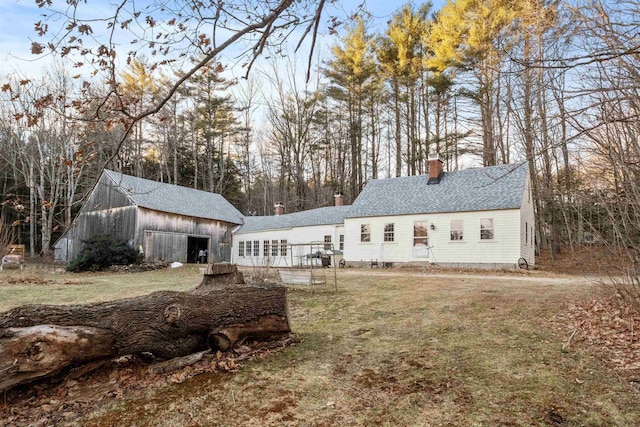 view of front of house with an outbuilding and a front yard