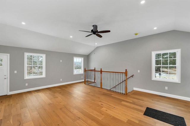 empty room featuring light wood-type flooring, vaulted ceiling, and ceiling fan