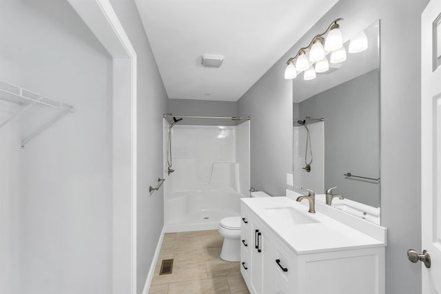 bathroom featuring toilet, vanity, a shower, and tile patterned floors