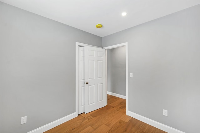 unfurnished bedroom with light wood-type flooring