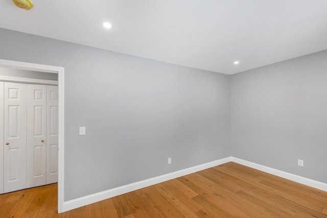 empty room with hardwood / wood-style flooring