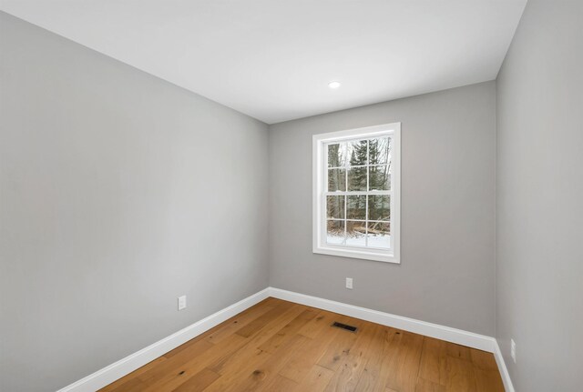 unfurnished room featuring hardwood / wood-style flooring