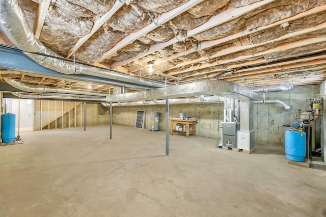 basement featuring electric water heater and heating unit