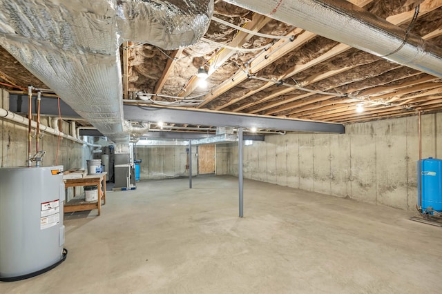 basement featuring electric water heater and heating unit