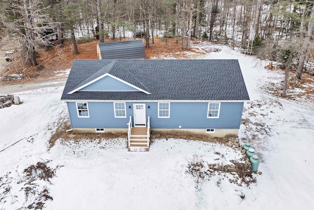 view of snow covered rear of property