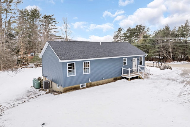 snow covered property with cooling unit