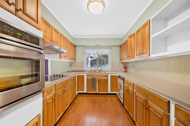 kitchen with decorative backsplash, ornamental molding, stainless steel oven, black electric cooktop, and sink