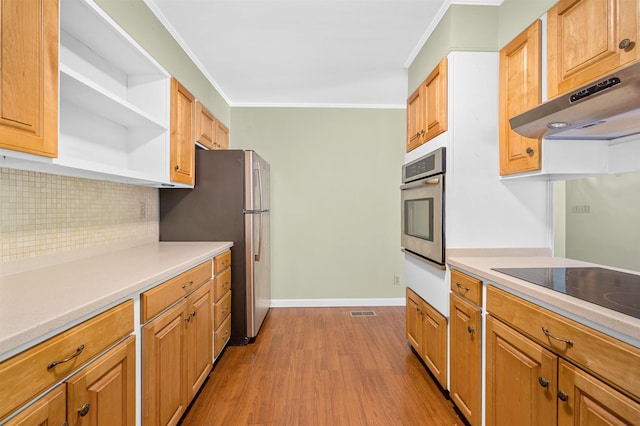 kitchen with backsplash, stainless steel appliances, ornamental molding, and light hardwood / wood-style floors