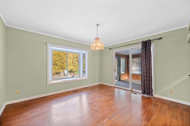 unfurnished dining area with a notable chandelier, wood-type flooring, and ornamental molding