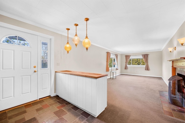 entrance foyer with dark colored carpet and ornamental molding