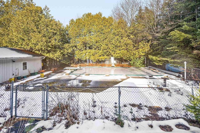 snow covered pool featuring a diving board