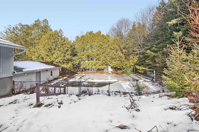 yard layered in snow featuring a covered pool