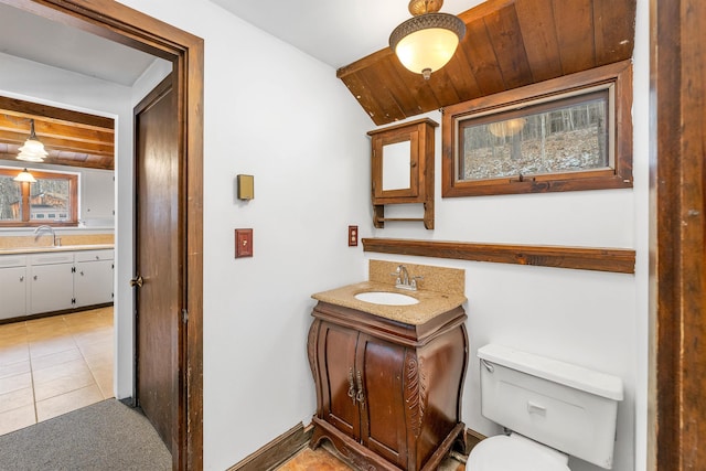 bathroom featuring tile patterned floors, vanity, wood ceiling, and toilet