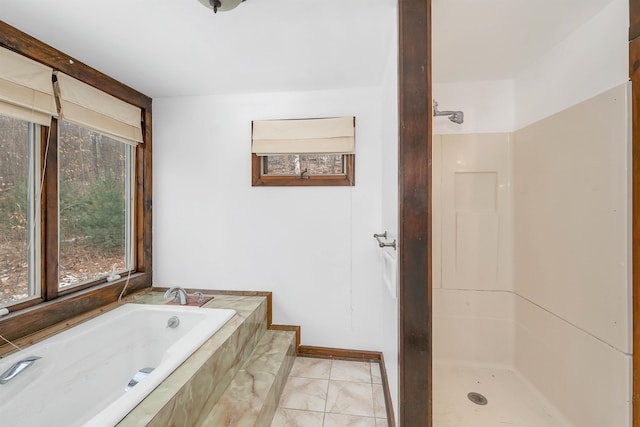 bathroom featuring shower with separate bathtub