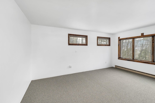 spare room with carpet floors and a baseboard radiator