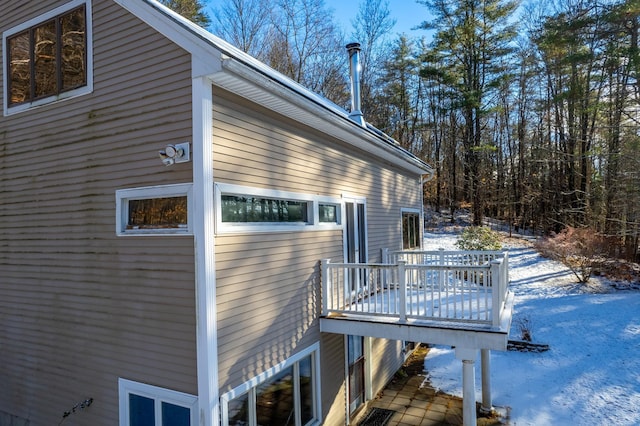 snow covered property featuring a wooden deck