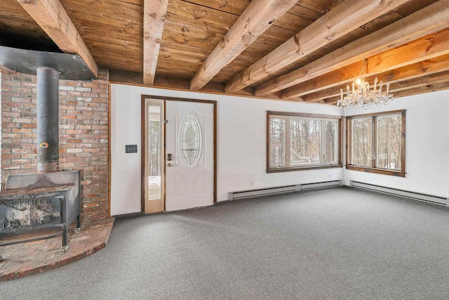 carpeted foyer featuring beam ceiling, a wood stove, a notable chandelier, and wood ceiling