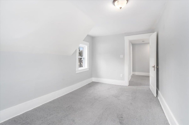 bonus room featuring light colored carpet and lofted ceiling