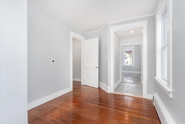 entryway with dark hardwood / wood-style floors, a baseboard radiator, and crown molding