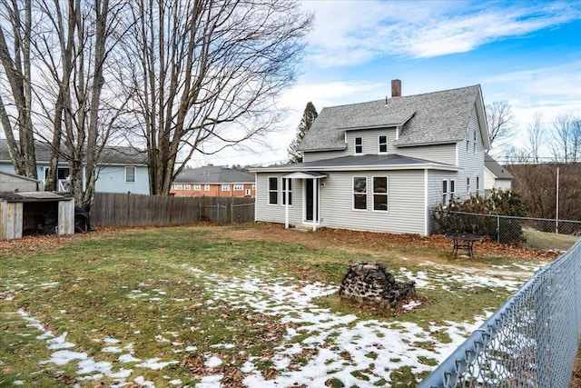 snow covered property with a lawn