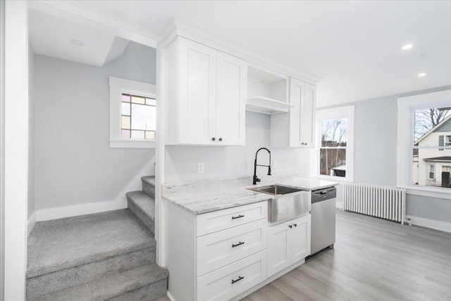 kitchen featuring white cabinets, dishwasher, radiator heating unit, and sink