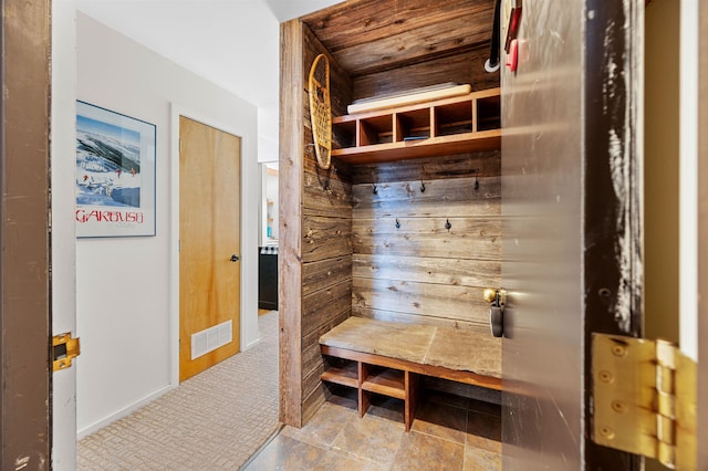 mudroom featuring wood walls and wood ceiling