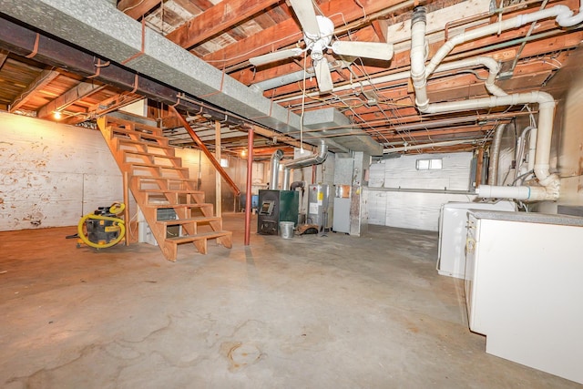 below grade area featuring washer / dryer, electric water heater, and stairway