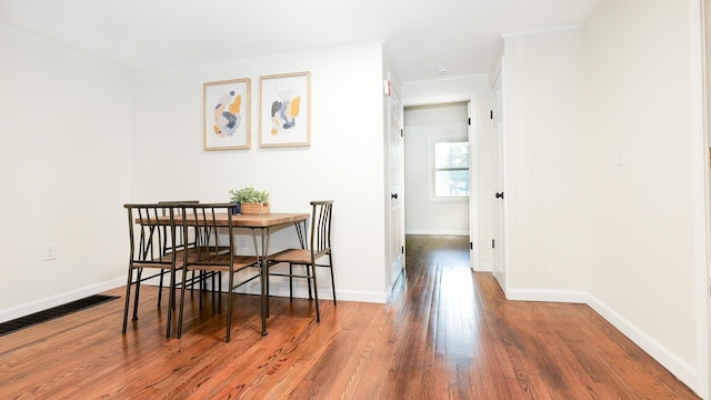 dining area featuring baseboards and wood finished floors