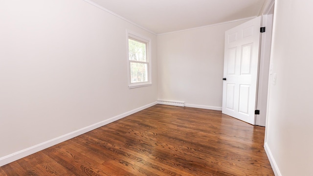 unfurnished room featuring a baseboard heating unit, dark wood finished floors, baseboards, and ornamental molding