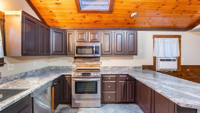 kitchen featuring vaulted ceiling with skylight, dark brown cabinets, and appliances with stainless steel finishes